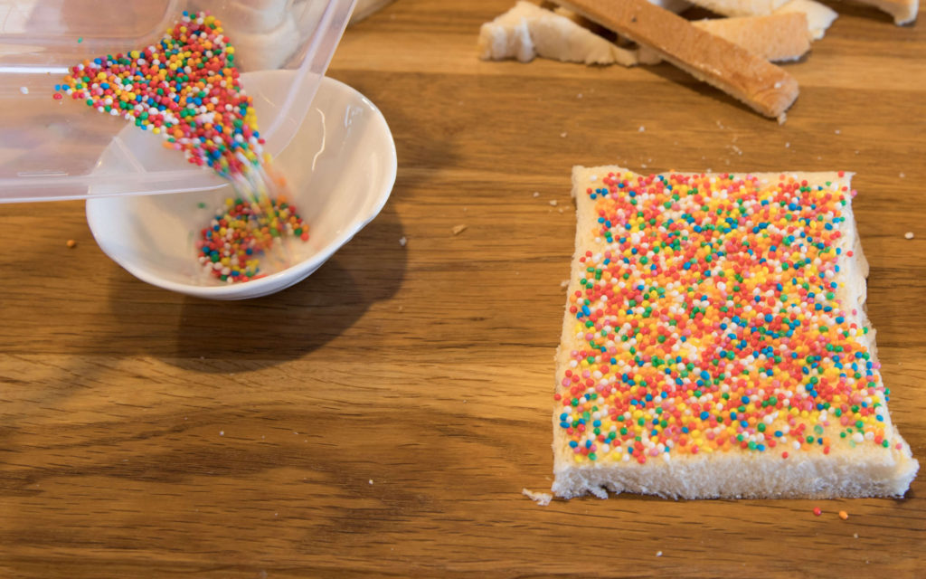 Making Fairy Bread for Fairy Bread day can be a messy process.